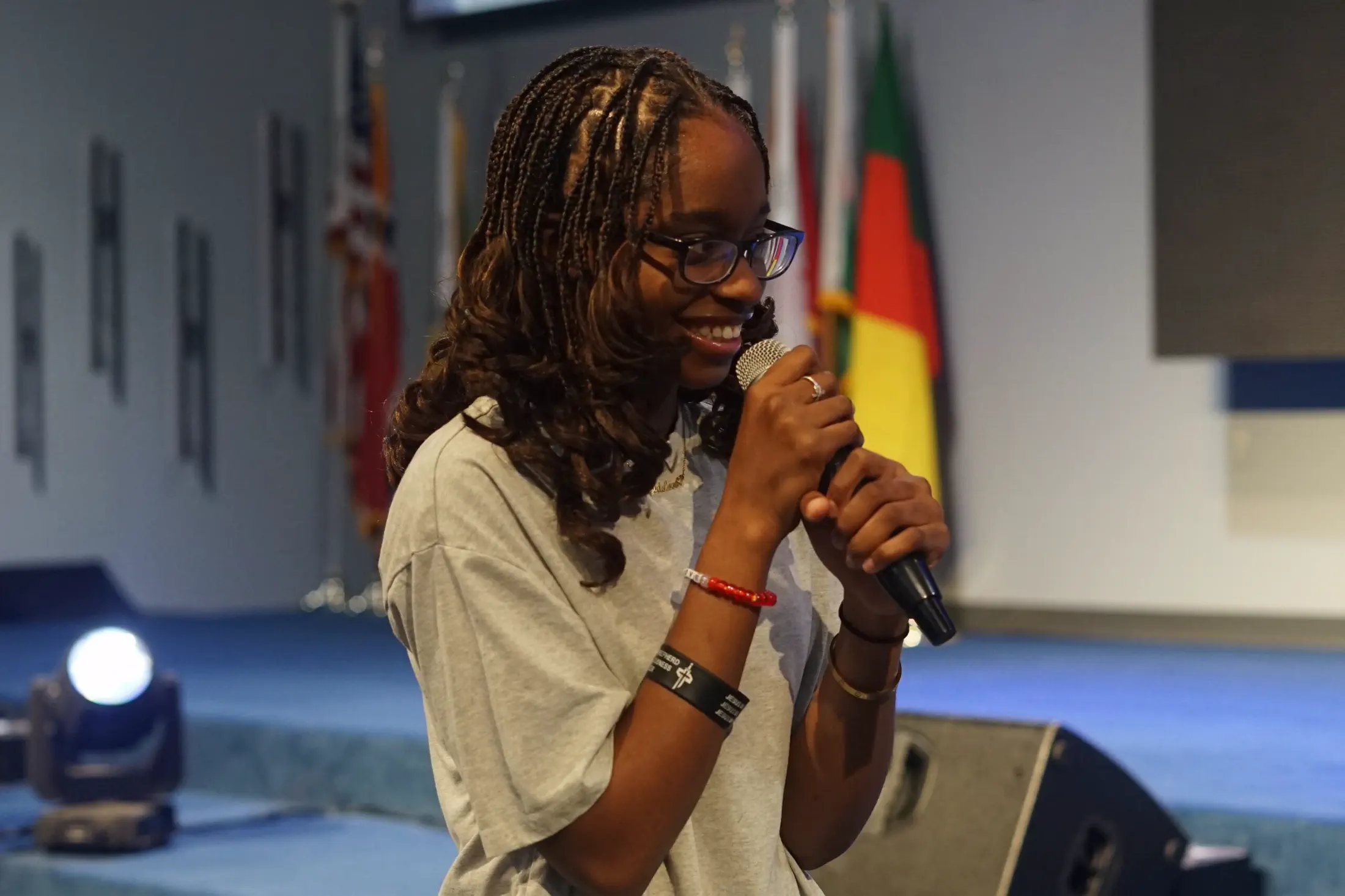 A student leading worship with a microphone.